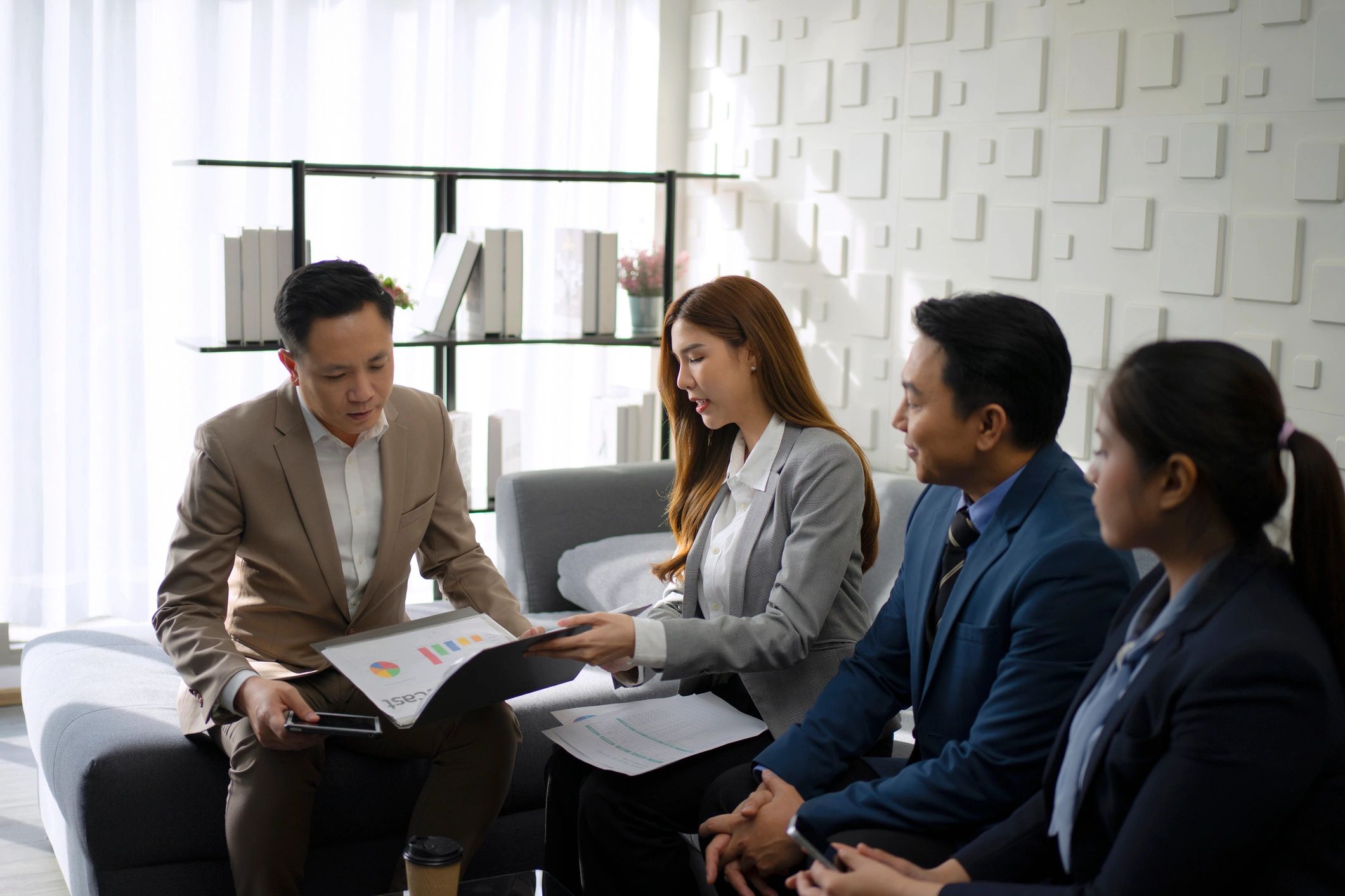 Business professionals reviewing financial information in an office meeting